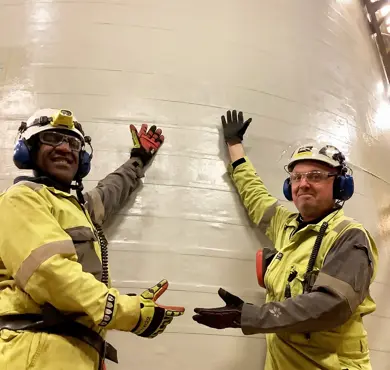 It's a wrap! Surface foreman Umer Genemo Duri and Supervisor Lars Jørgen Persson proudly show off the wrapped tank. Photo: Beerenberg.